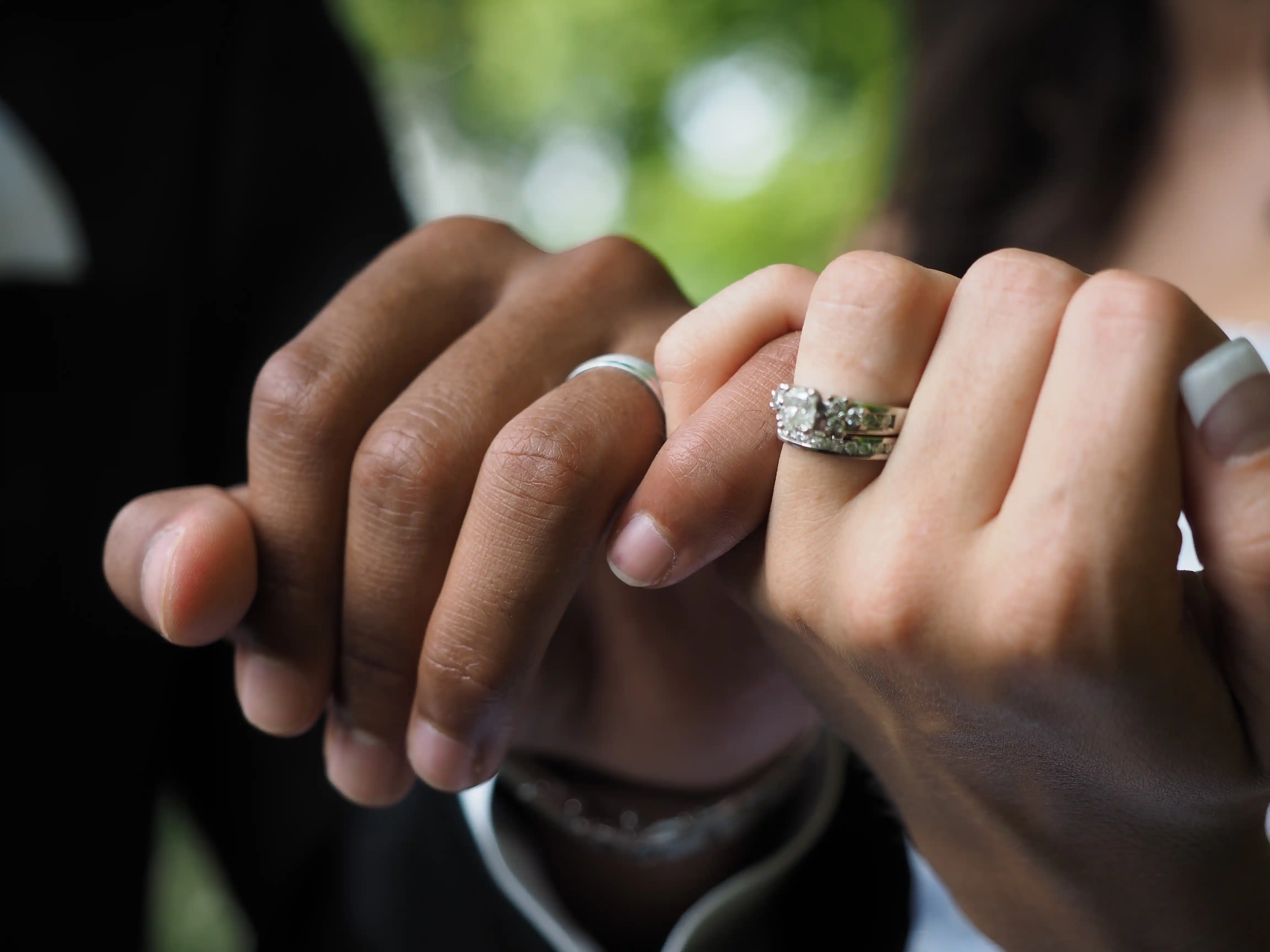 closeup-of-a-couple-with-wedding-rings-holding-hand