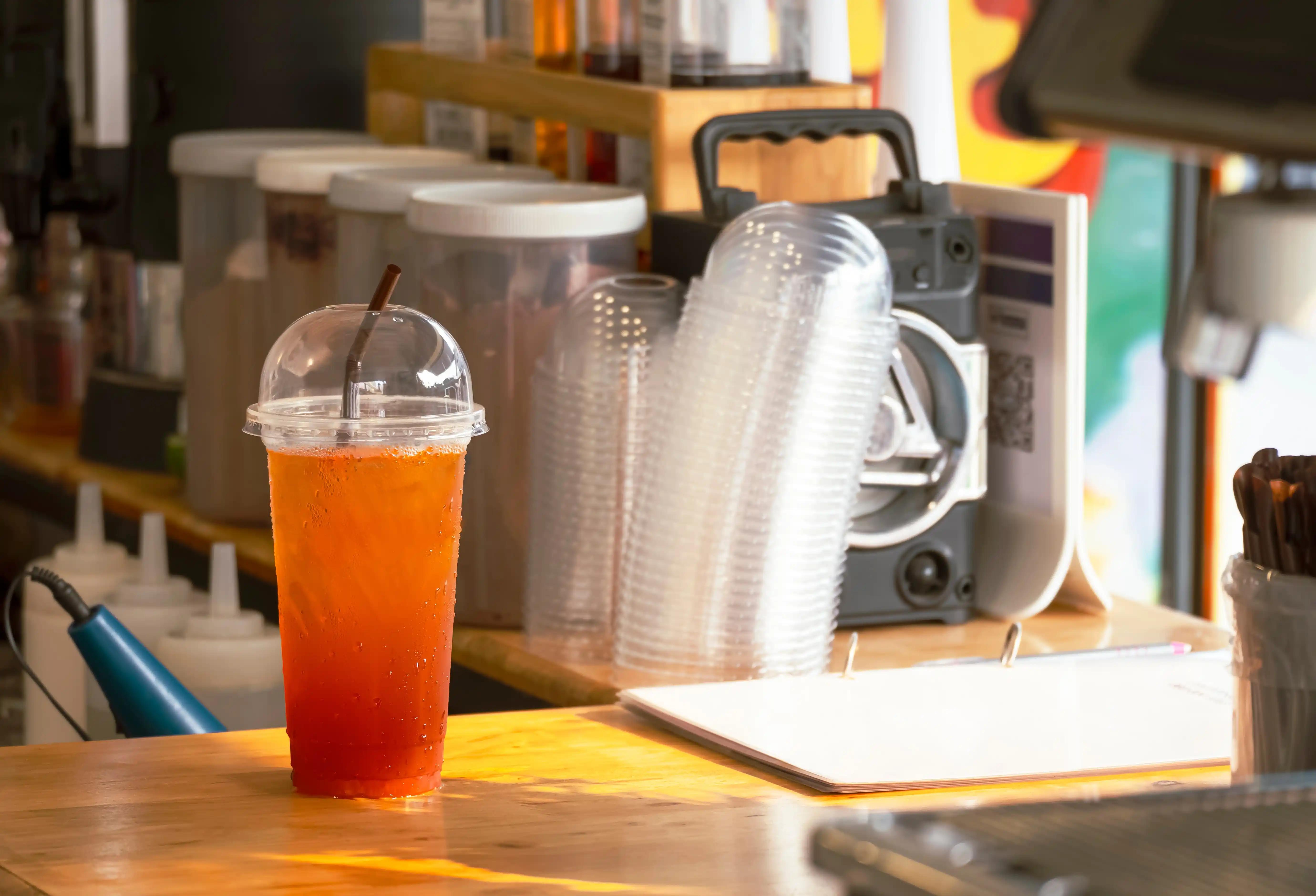 iced-lemon-tea-in-plastic-glass-on-wooden-counter